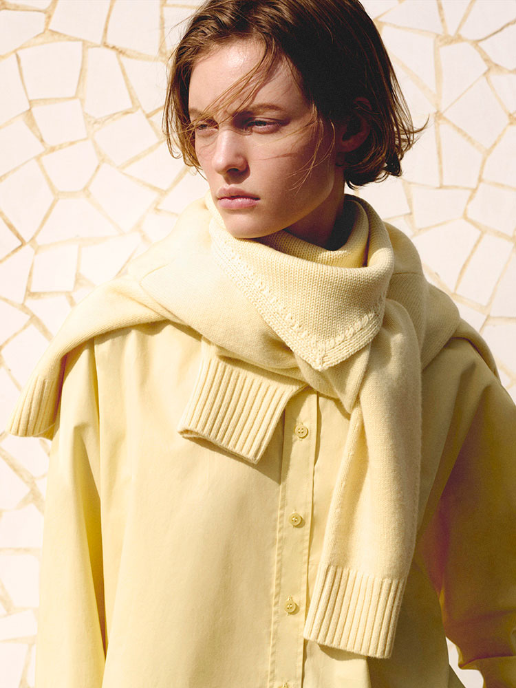 man wearing turtleneck standing on balcony